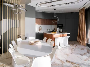 Open-plan kitchen and dining space with marble floors and sea-view windows in Meltemi Villa.