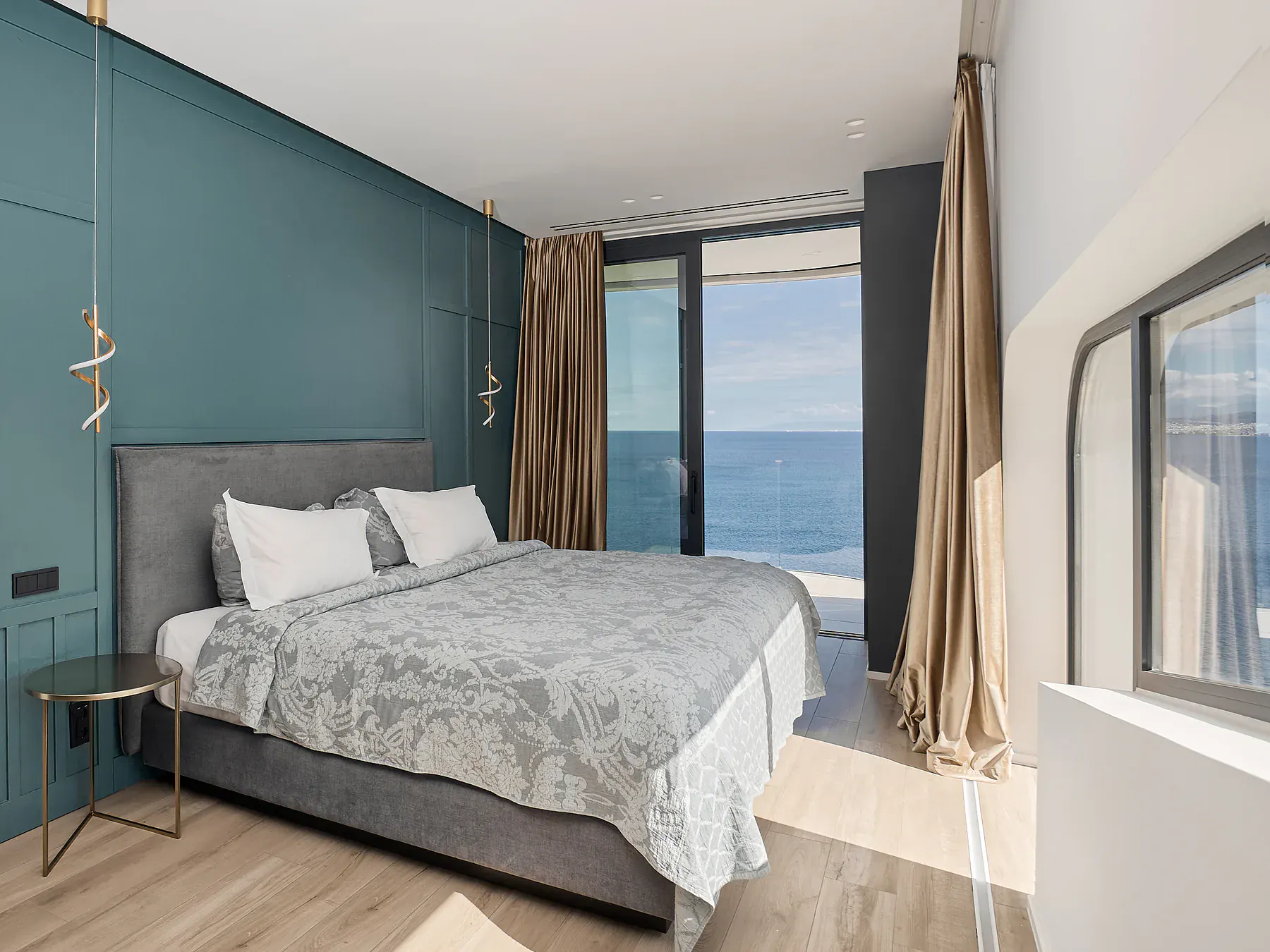 Cozy bedroom with ocean-facing windows and natural light.